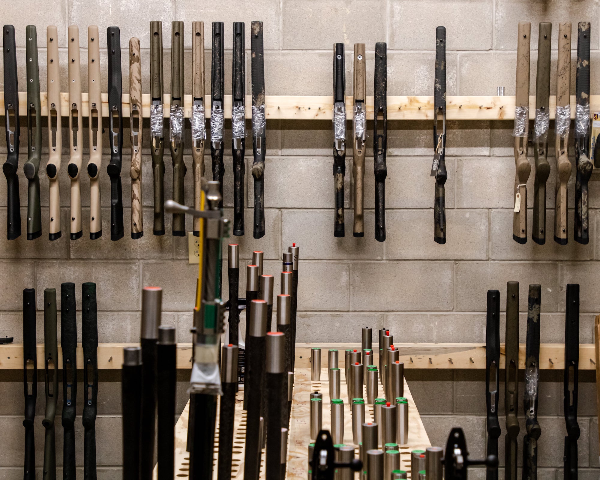 A wall of custom rifle parts